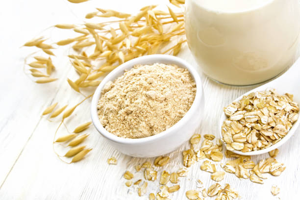 istock Flour oat in bowl with milk on board 1136322760