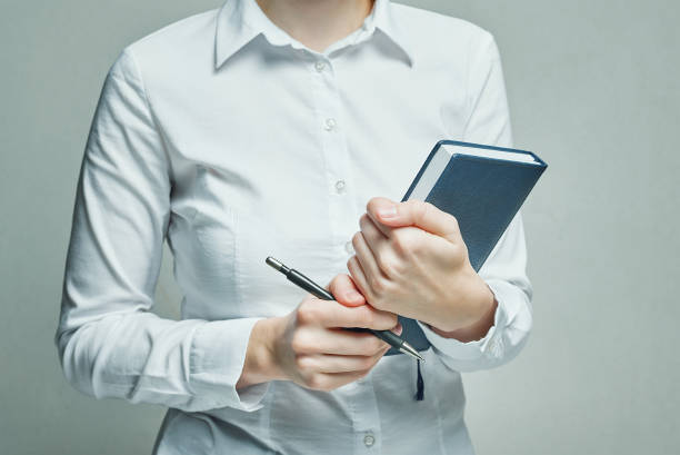 istock Businesswoman with organizer diary in her hands 1136322998