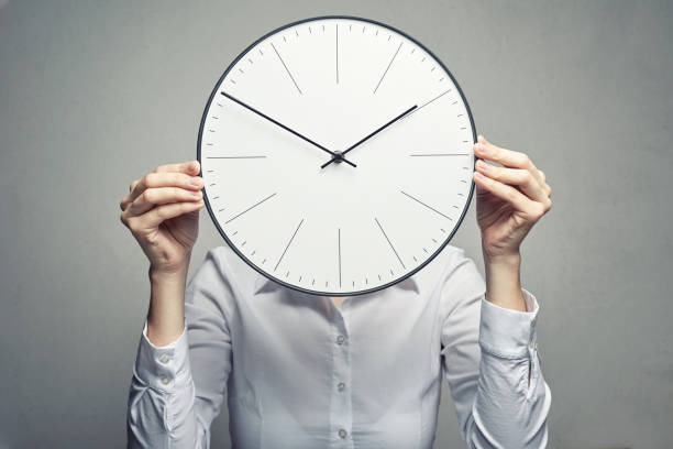 istock business woman covering her face with clock 1136323002