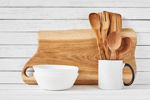 istock Cooking utensils and cutting board on white table 1136323060