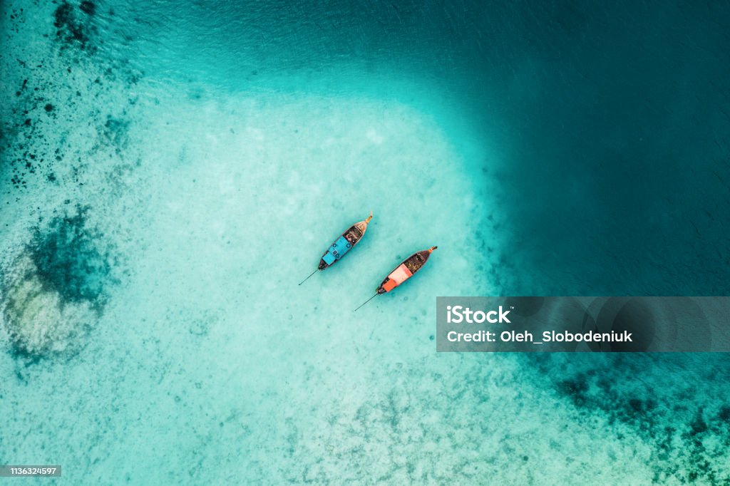 Scenic aerial view of two boats on sea in Thailand Scenic aerial view of two boats on sea near Koh Phi Phi, Thailand Thailand Stock Photo