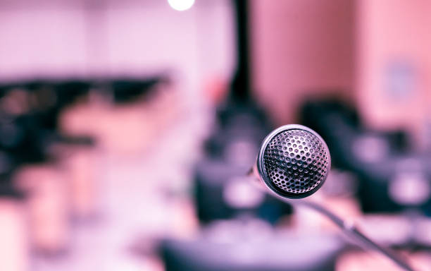 istock Microphone in the computer room for talker  announcement to listener with de-focused background, selective focus on microphone 1136324791