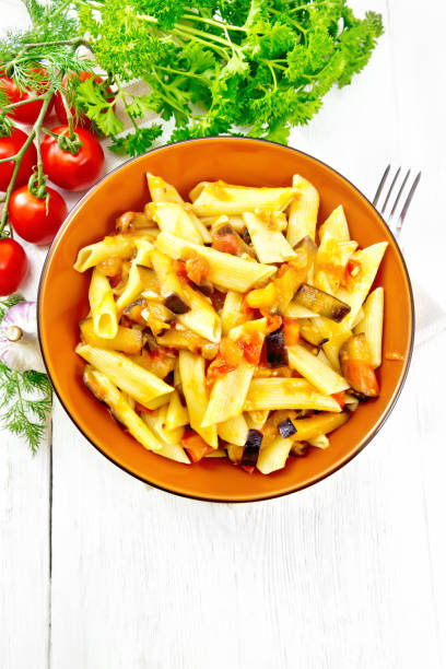 istock Pasta penne with eggplant and tomatoes on board top 1136325693