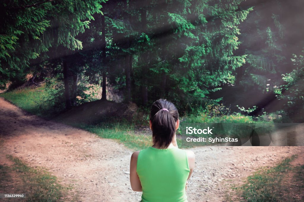 Girl with a choice near the forked road Footpath Stock Photo