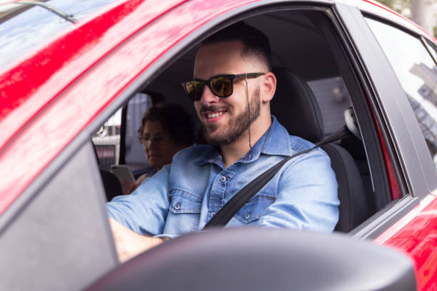 istock Smiling Young Man Driving Car 1136331758