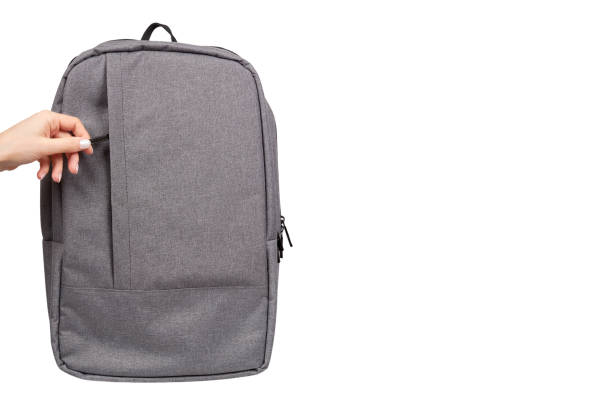 istock Hand with gray textile school bag, city street backpack 1136335309
