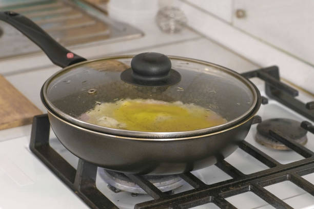 istock Preparing scrambled eggs with sausage in a frying pan on gas stove. 1136340495