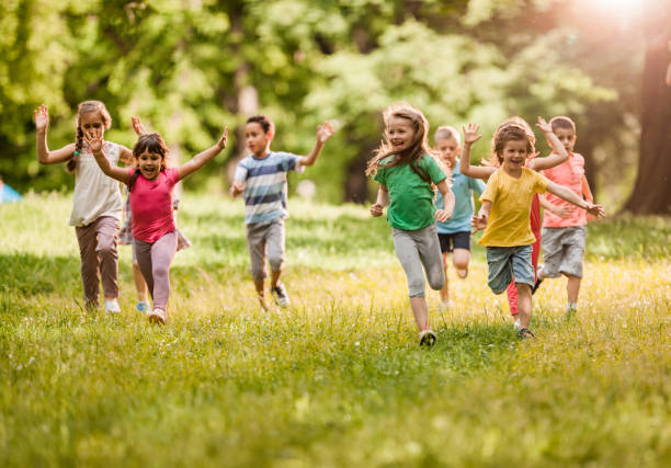 istock Playful children running in spring day at the park. 1136342690