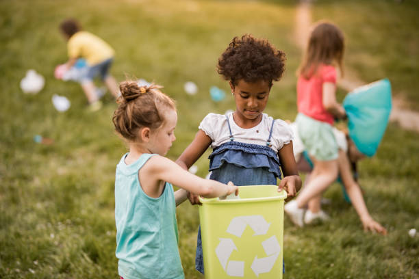 istock Children doing environmental cleanup during spring day at the park. 1136342897