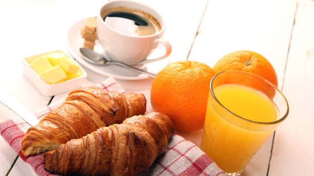 istock Breakfast with coffee, orange juice, butter and croissants 1136343575