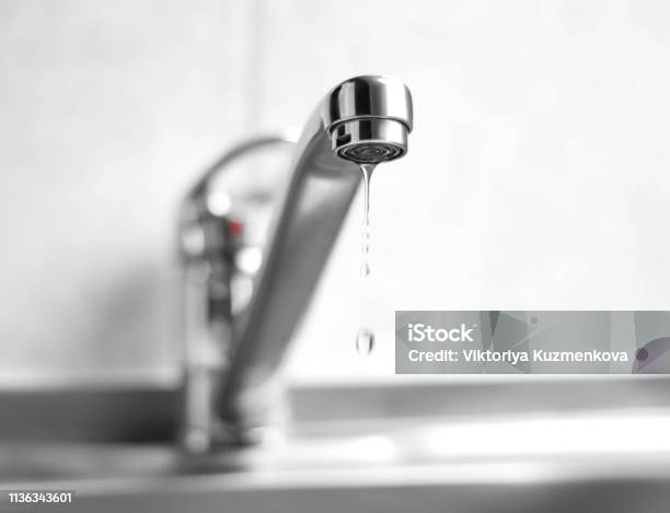 Water Is Dripping From A Metal Water Tap Close Up Stock Photo - Download Image Now - Faucet, Leaking, Drop