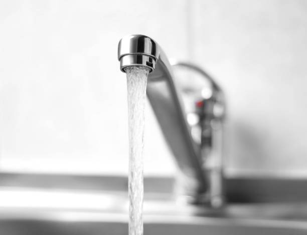 istock Water runs from a metal water tap. Close up 1136343603