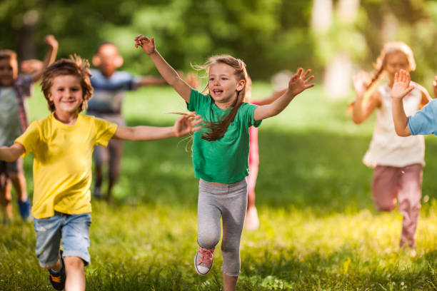 istock Happy little friends having fun while running in nature. 1136343621