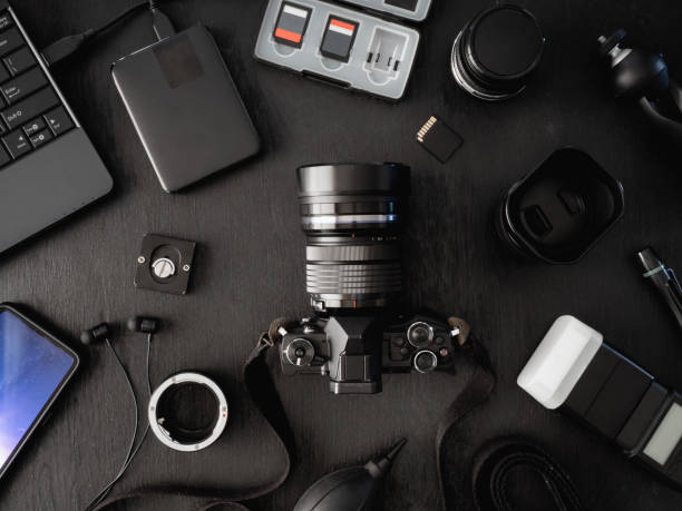 istock top view of work space photographer with digital camera, flash, cleaning kit, memory card, external harddisk, USB card reader, laptop and camera accessory on black table background 1136346852