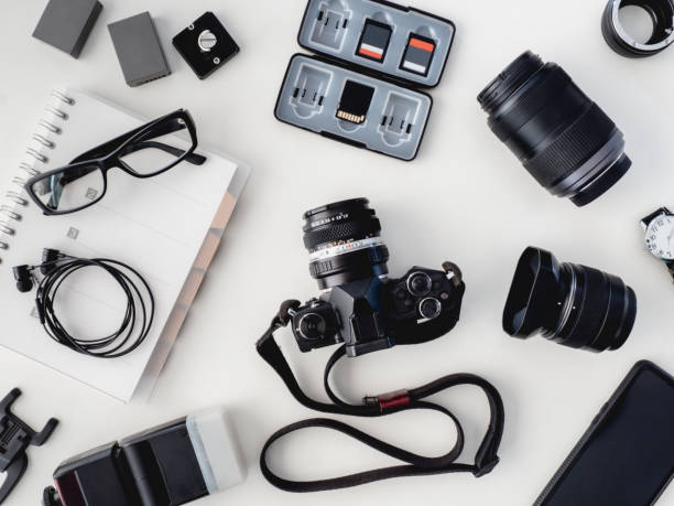 istock top view of work space photographer with digital camera, flash, cleaning kit, white table background. 1136346856