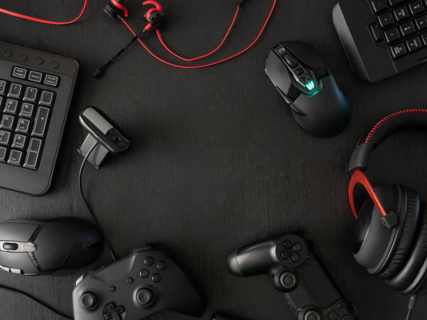 istock gamer workspace concept, top view a gaming gear, mouse, keyboard, joystick, headset, mobile joystick, in ear headphone and mouse pad on black table background. 1136346857