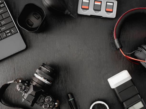 istock top view of work space photographer with digital camera, flash, cleaning kit, memory card, external harddisk, USB card reader, laptop and camera accessory on black table background 1136346883