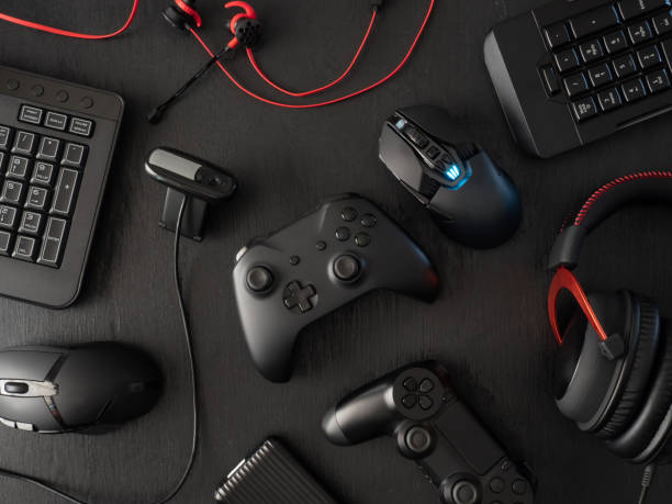 istock gamer workspace concept, top view a gaming gear, mouse, keyboard, joystick, headset, mobile joystick, in ear headphone and mouse pad on black table background. 1136346884