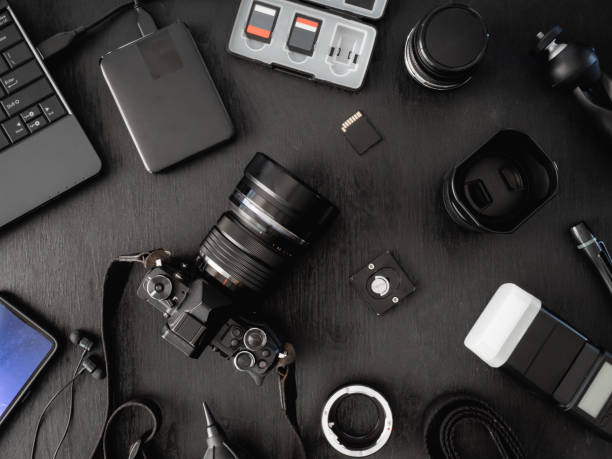 istock top view of work space photographer with digital camera, flash, cleaning kit, memory card, external harddisk, USB card reader, laptop and camera accessory on black table background 1136346885