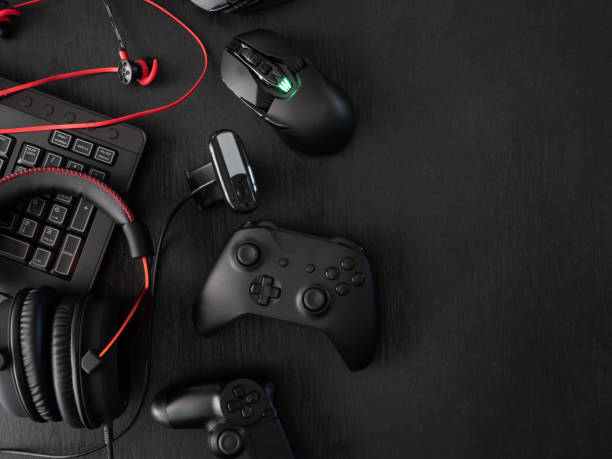 istock gamer workspace concept, top view a gaming gear, mouse, keyboard, joystick, headset, mobile joystick, in ear headphone and mouse pad on black table background. 1136346888