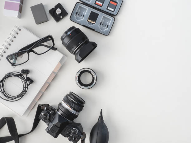 istock top view of work space photographer with digital camera, flash, cleaning kit, white table background. 1136346907