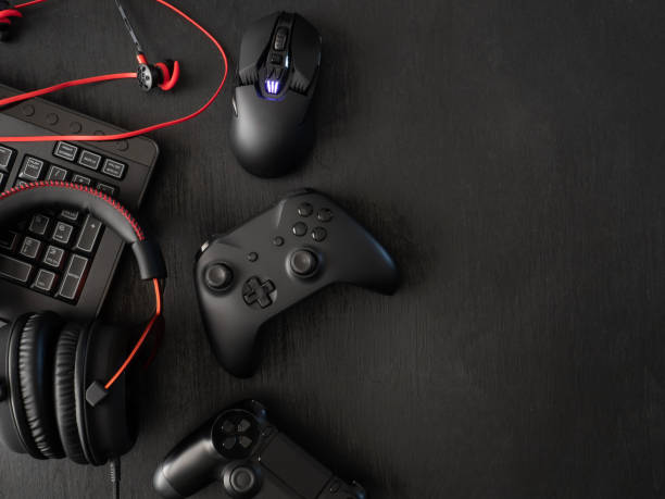 istock gamer workspace concept, top view a gaming gear, mouse, keyboard, joystick, headset, mobile joystick, in ear headphone and mouse pad on black table background. 1136346925