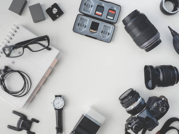 istock top view of work space photographer with digital camera, flash, cleaning kit, white table background. 1136346935