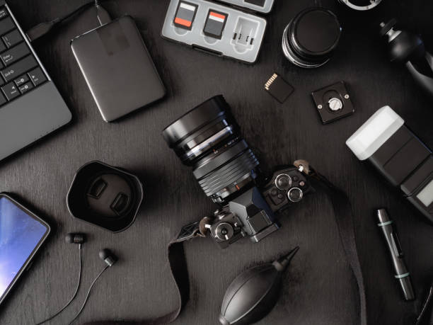 istock top view of work space photographer with digital camera, flash, cleaning kit, memory card, external harddisk, USB card reader, laptop and camera accessory on black table background 1136346937
