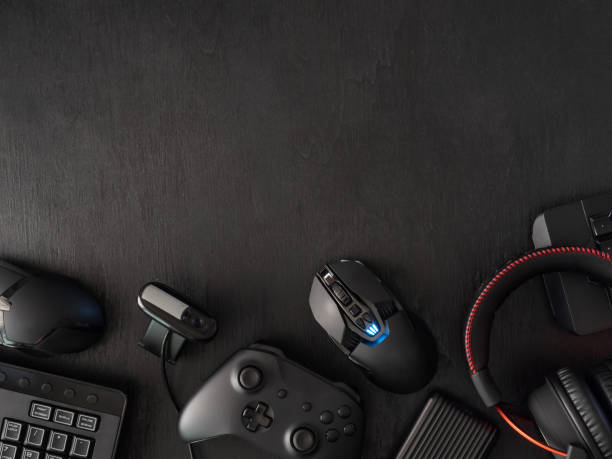 istock gamer workspace concept, top view a gaming gear, mouse, keyboard, joystick, headset, mobile joystick, in ear headphone and mouse pad on black table background. 1136346939