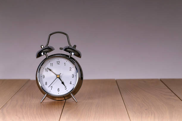 istock The old alarm clock on a light background 1136349300