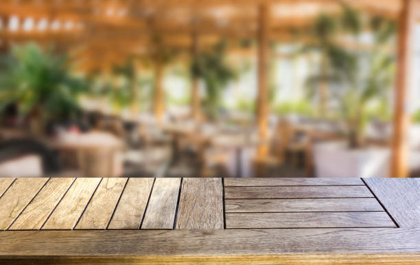 istock Wood table top on blur cafe background 1136355081