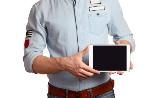 istock A man in a light blue shirt is holding tablet pc isolated on white background 1136358358