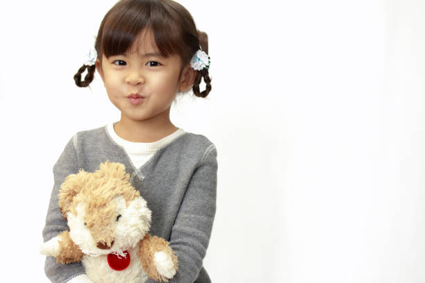 istock Japanese girl holding a stuffed rabbit (4 years old) (white back) 1136360723