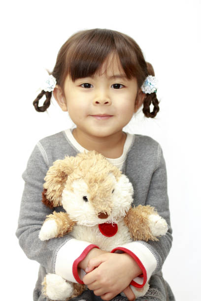 istock Japanese girl holding a stuffed rabbit (4 years old) (white back) 1136360926
