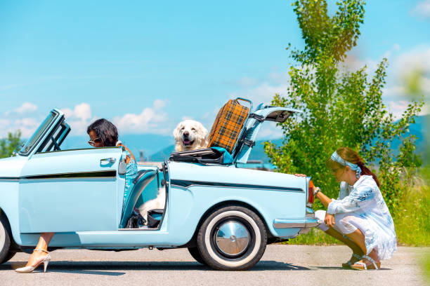 Mature Couple on a Road trip Fixing a Broken Vintage car