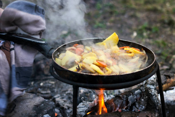 istock Potatoes with vegetables in a frying pan with smoke, cooked on fire 1136363269