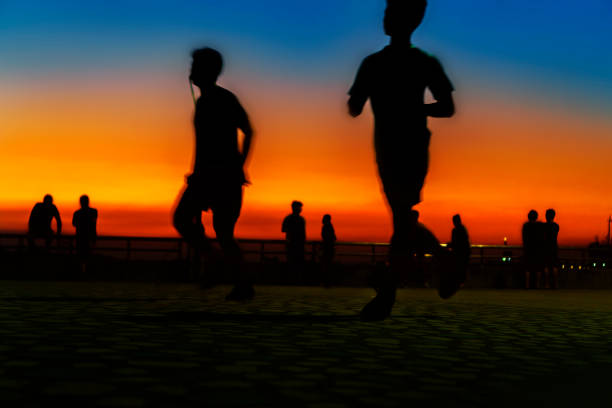 istock Shadow of the jogging person at sunset 1136365004