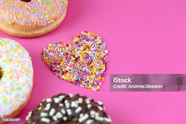 Doughnuts And Sprinkles Stock Photo - Download Image Now - Doughnut, Heart Shape, Baked