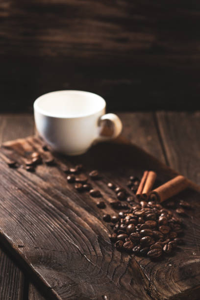 istock Coffee beans and white mug on wood 1136367305