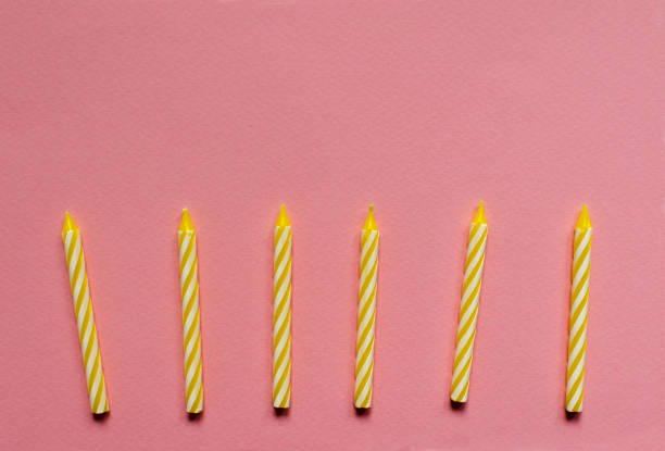 istock multicolored candles for cake on paper background 1136367678