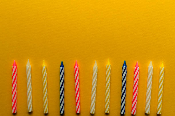 istock multicolored candles for cake on paper background 1136367774
