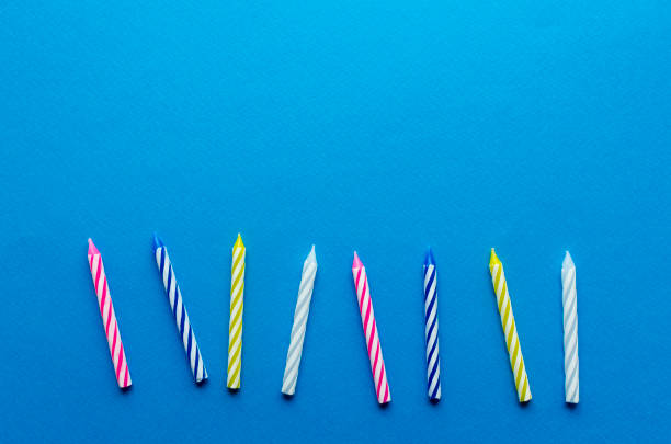 istock multicolored candles for cake on paper background 1136367812
