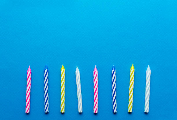 istock multicolored candles for cake on paper background 1136367813