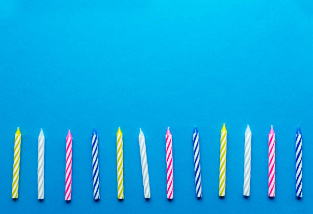 istock multicolored candles for cake on paper background 1136367815
