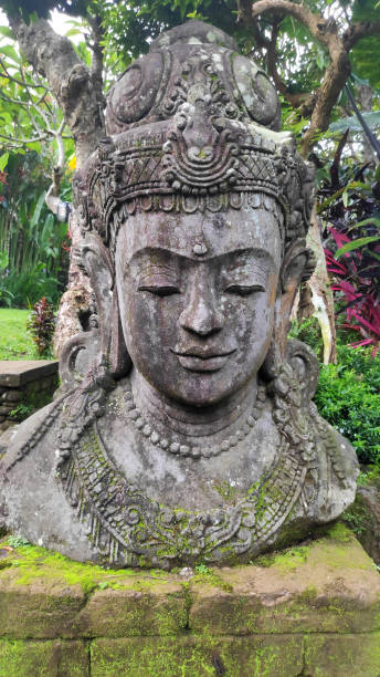 istock Buddha image in the tropical garden in Bali 1136368909
