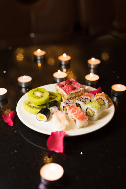 istock Some desserts on a table decorated with rose petals and candles 1136370177