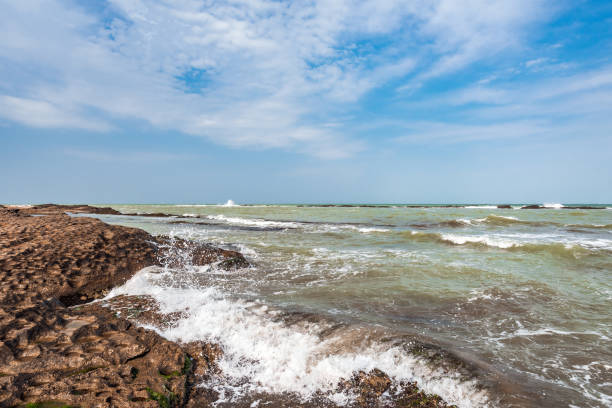 istock Splash of waves on a rocky seashore 1136370196