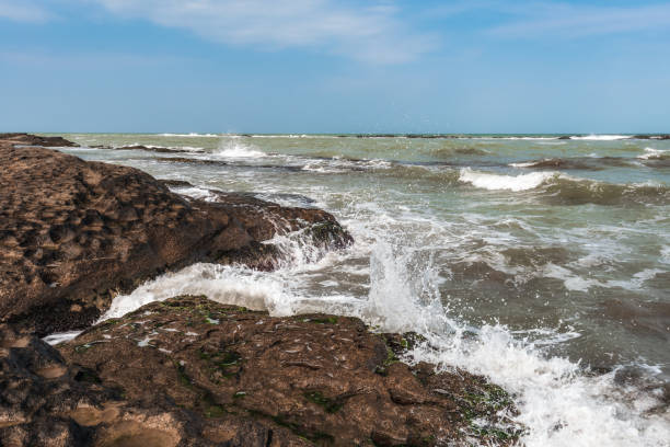 istock Splash of waves on a rocky seashore 1136370238