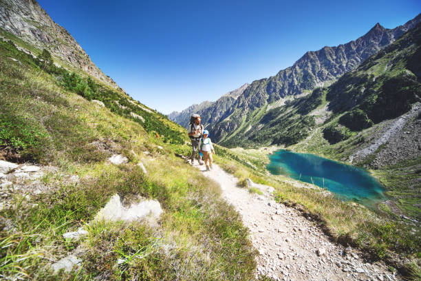 istock Father and son hiking together in mountains 1136371026