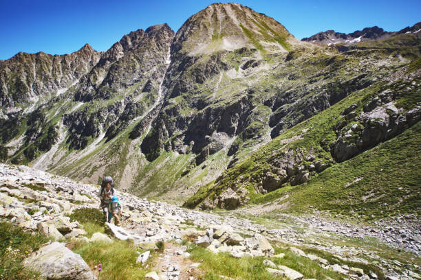 istock Father and son hiking together in mountains 1136371041
